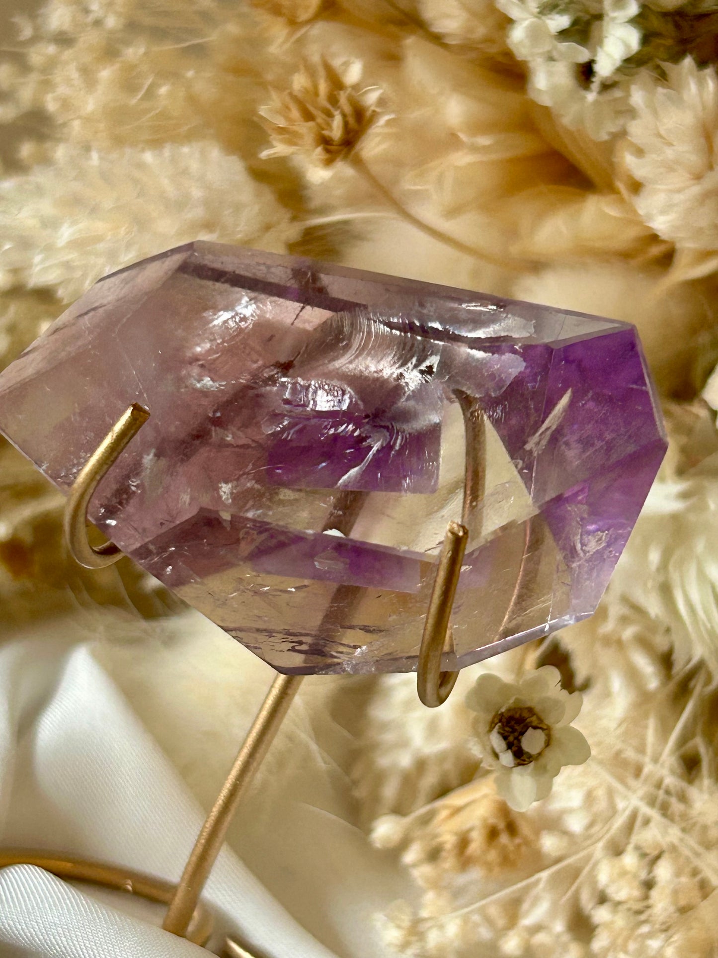 Gem-quality Phantom Amethyst freeform with visible internal layering and rich violet tones, standing upright on a soft background