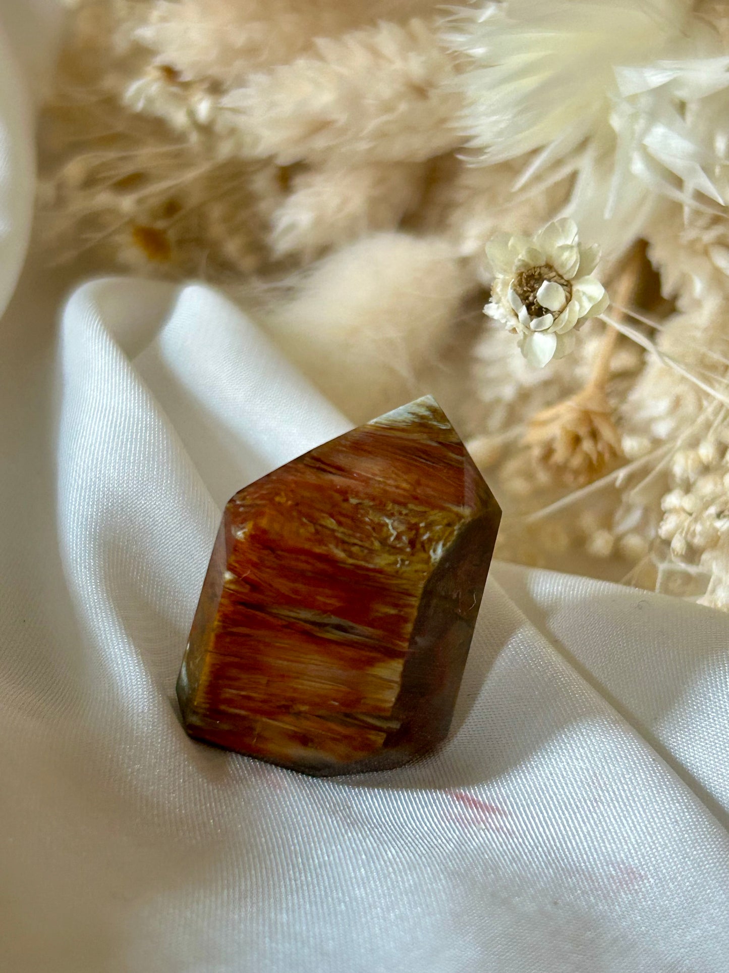 Amphibole Quartz crystal with soft cloud-like inclusions and gentle light play, standing upright on a neutral background
