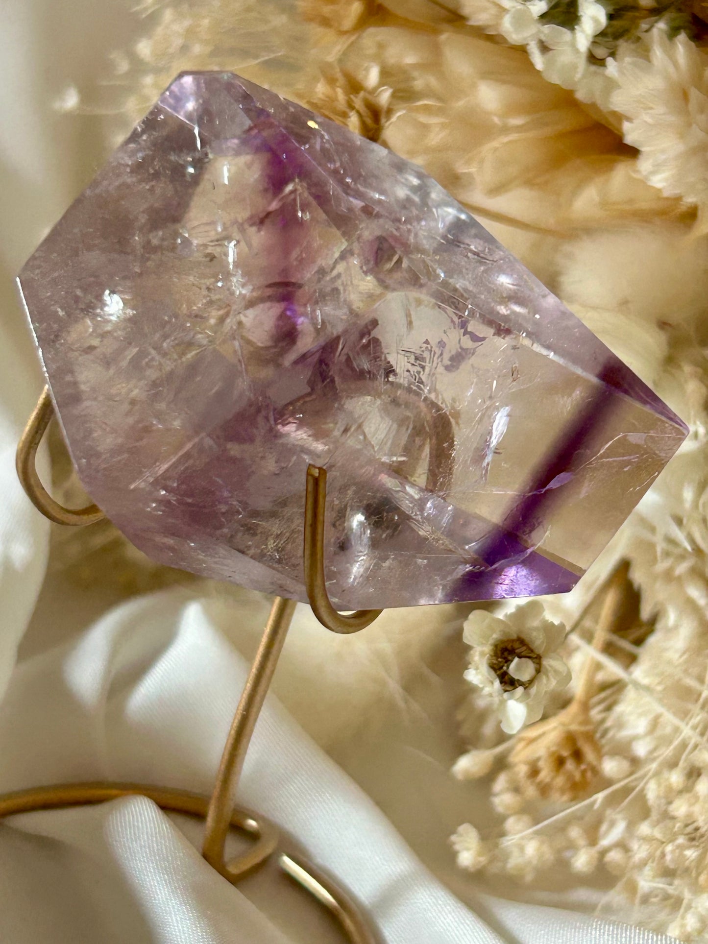 Gem-quality Phantom Amethyst freeform with visible internal layering and rich violet tones, standing upright on a soft background