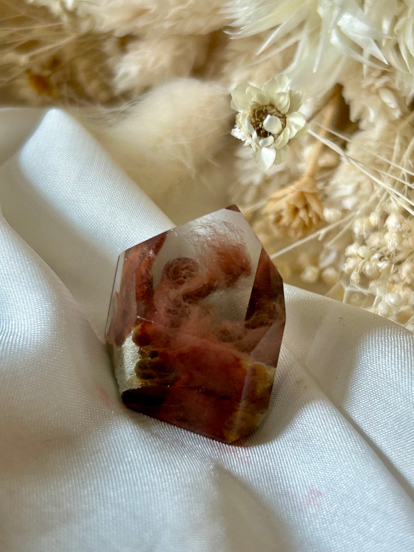 Amphibole Quartz crystal with soft cloud-like inclusions and gentle light play, standing upright on a neutral background