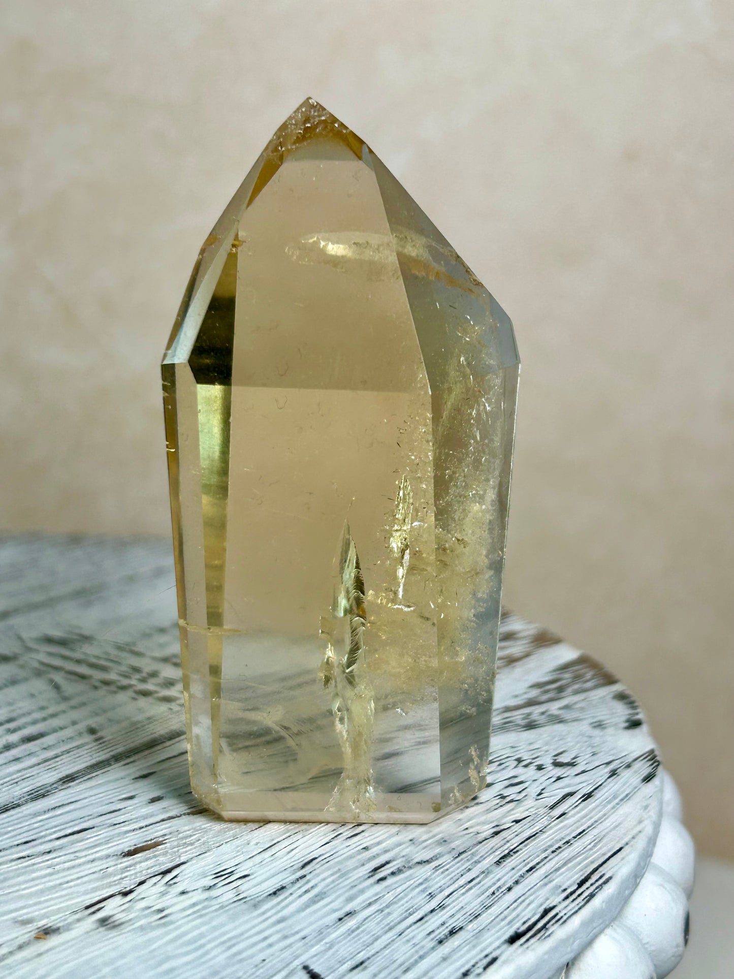 Citrine tower, honey colour on cream background and rustic wood surface