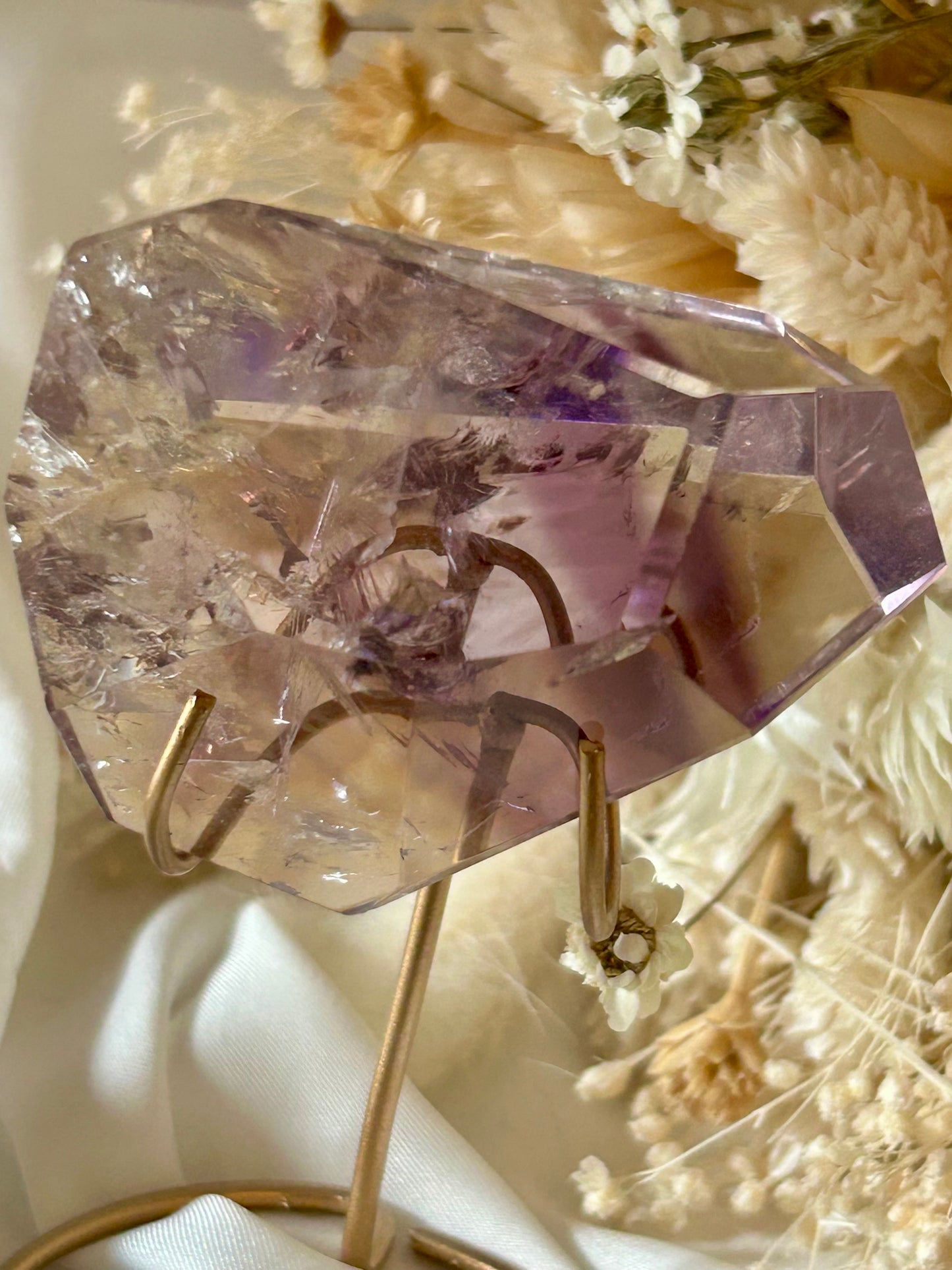 Gem-quality Phantom Amethyst freeform with visible internal layering and rich violet tones, standing upright on a soft background