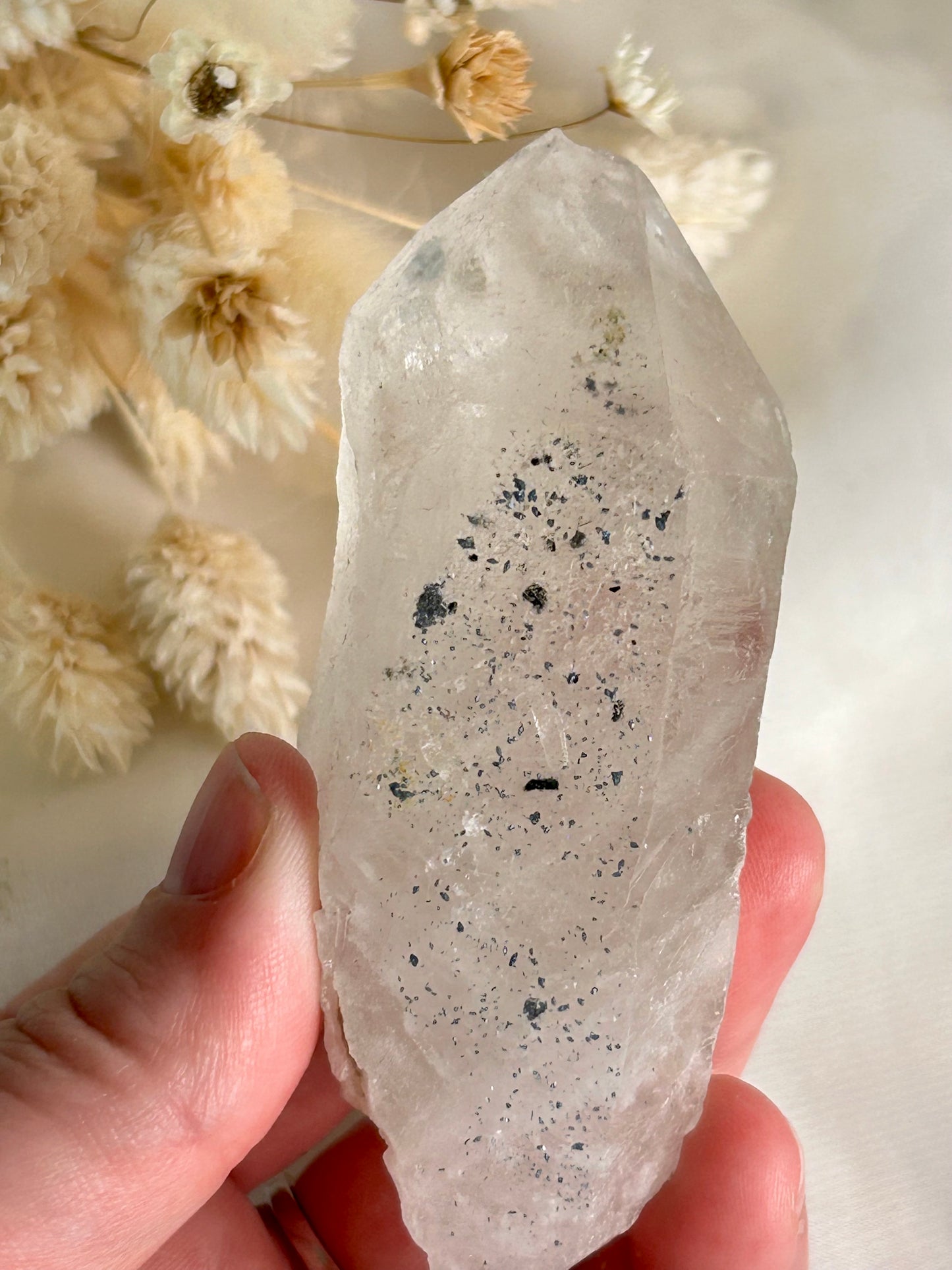 Clear Quartz point with blue inclusions, Anatase or Hematite