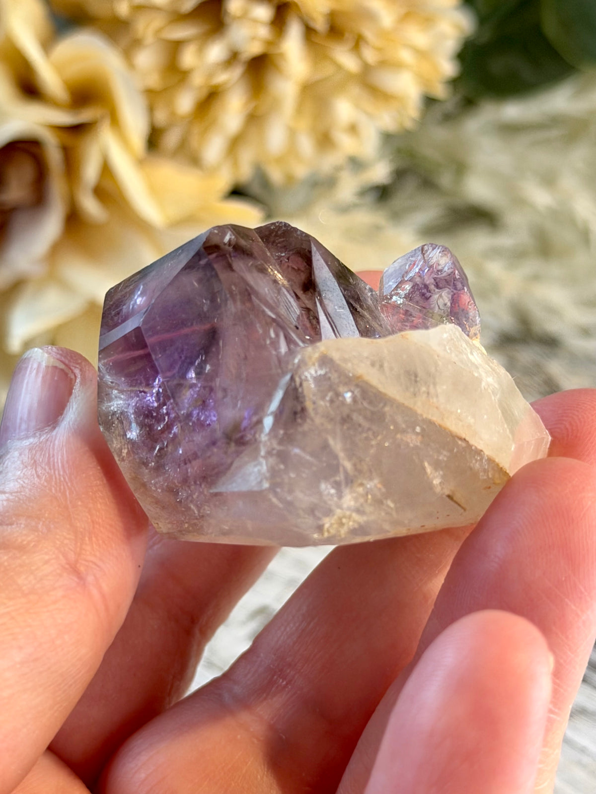 Polished Brazilian Amethyst Elestial with purple tones and intricate layered natural crystal formations.