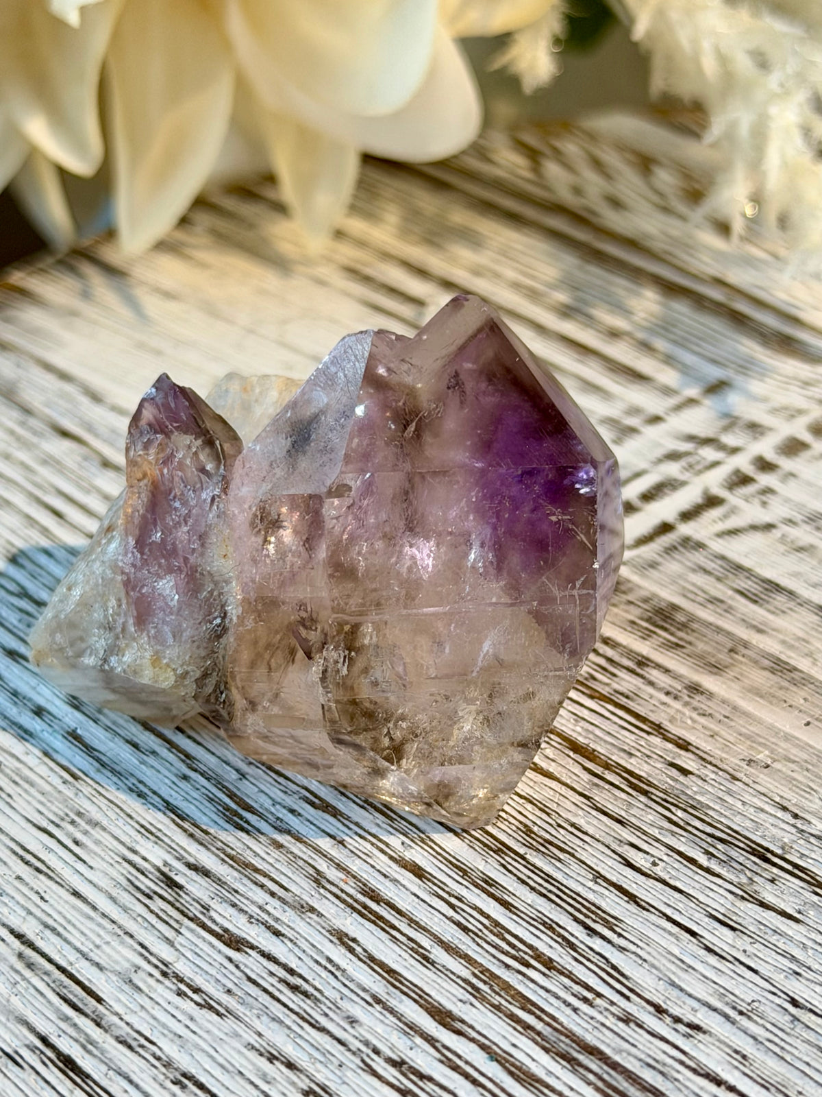 Polished Brazilian Amethyst Elestial with purple tones and intricate layered natural crystal formations.