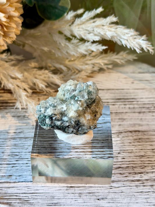Alien Heulandite mineral specimen featuring intricate translucent crystal clusters, silvery-blue tones, and natural crystalline growth.