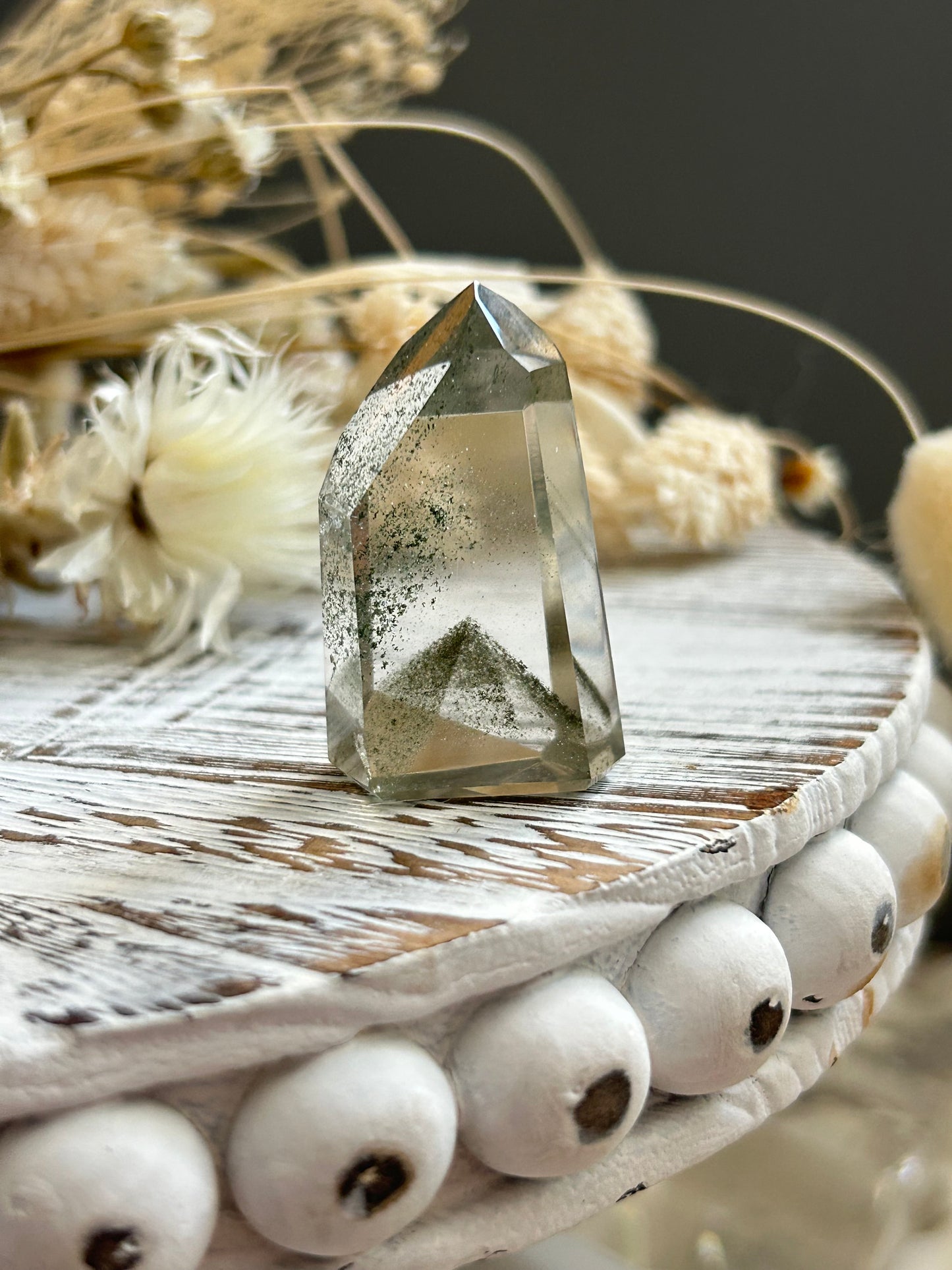 Chlorite phantom quartz point showing green chlorite inclusions and layered phantom growth within clear quartz.