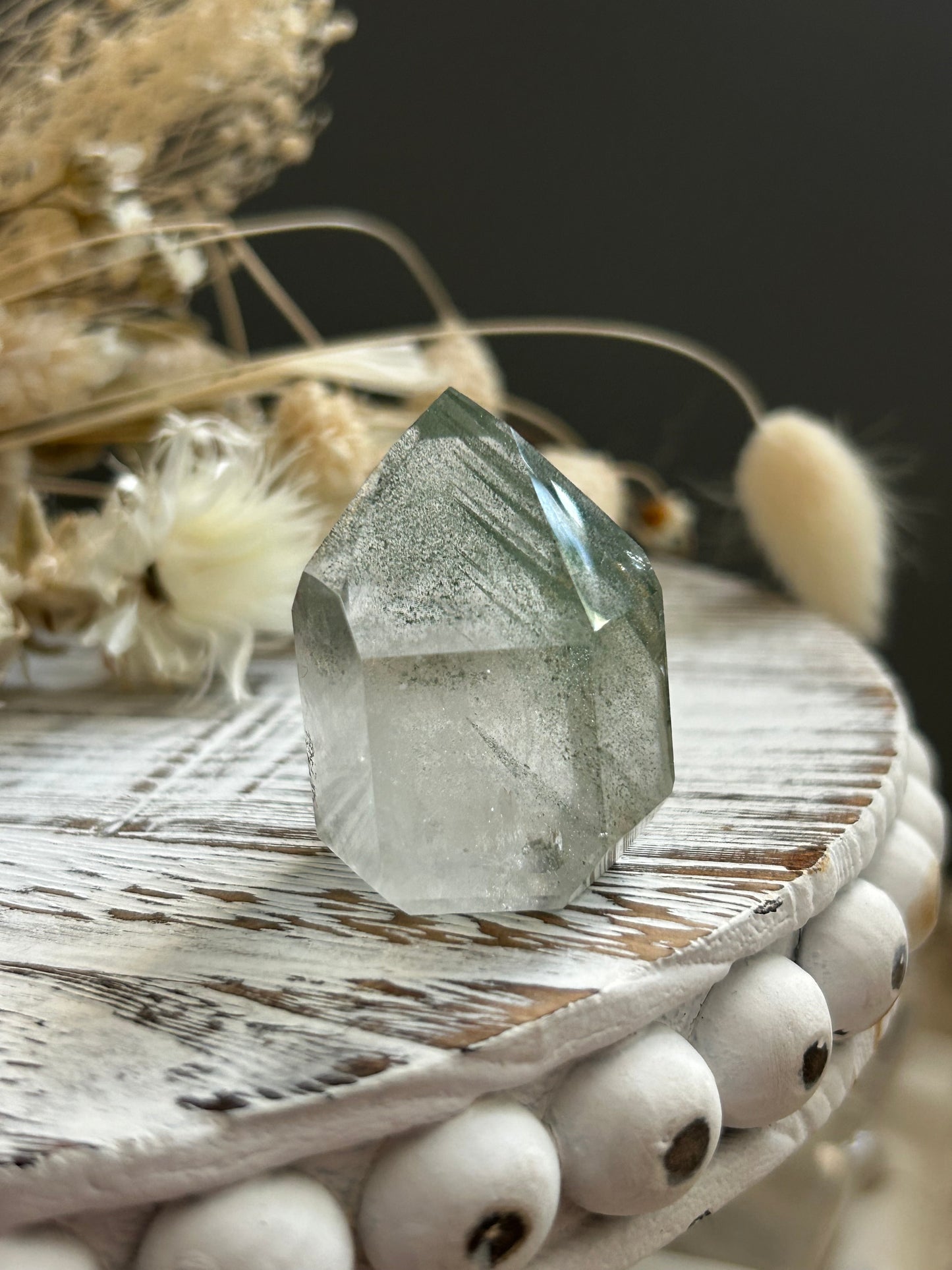 Chlorite phantom quartz point showing green chlorite inclusions and layered phantom growth within clear quartz.
