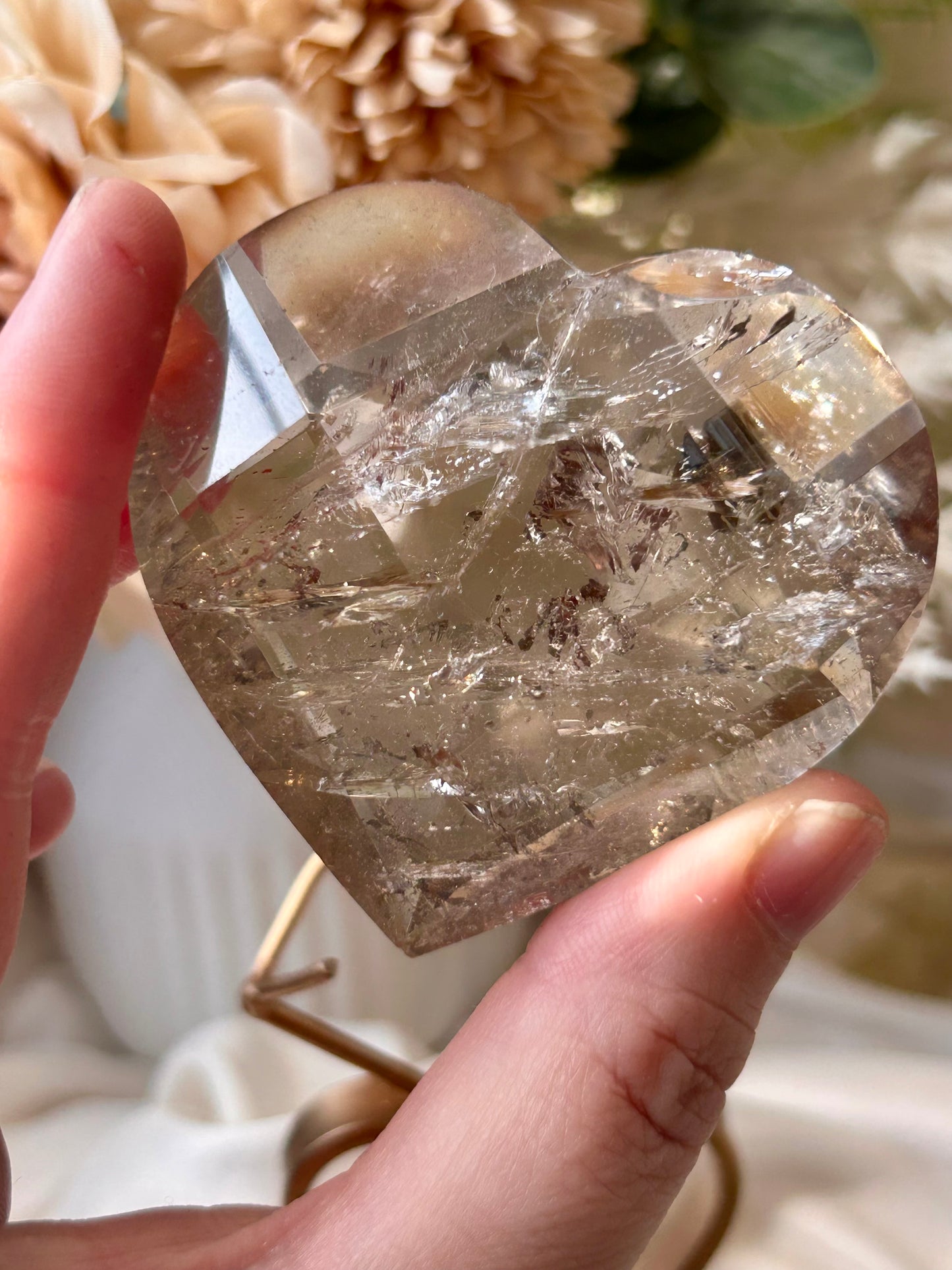 Faceted Smoky Quartz heart with natural smoky tones and custom crystal display stand.