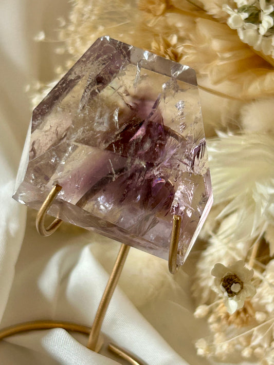 Gem-quality Phantom Amethyst freeform with visible internal layering and rich violet tones, standing upright on a soft background