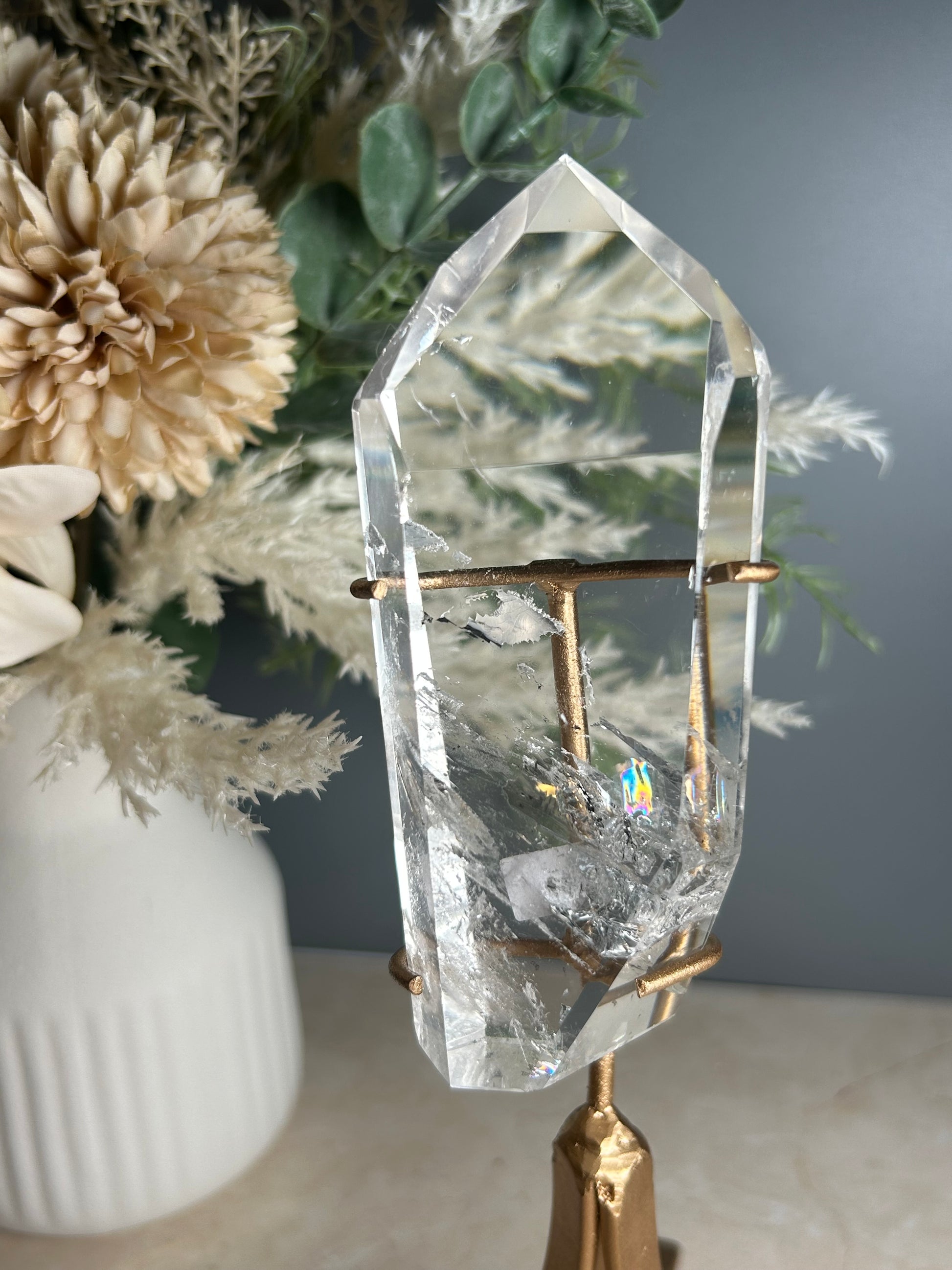 high grade polished clear quartz freeform crystal on gold display stand natural quartz specimen