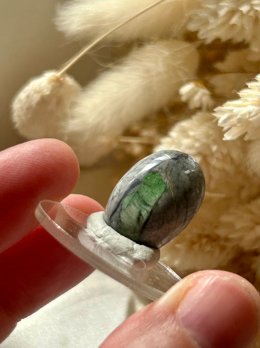 Polished green Smaragdite cabochon from France with visible actinolite inclusions – jewellery safe stone