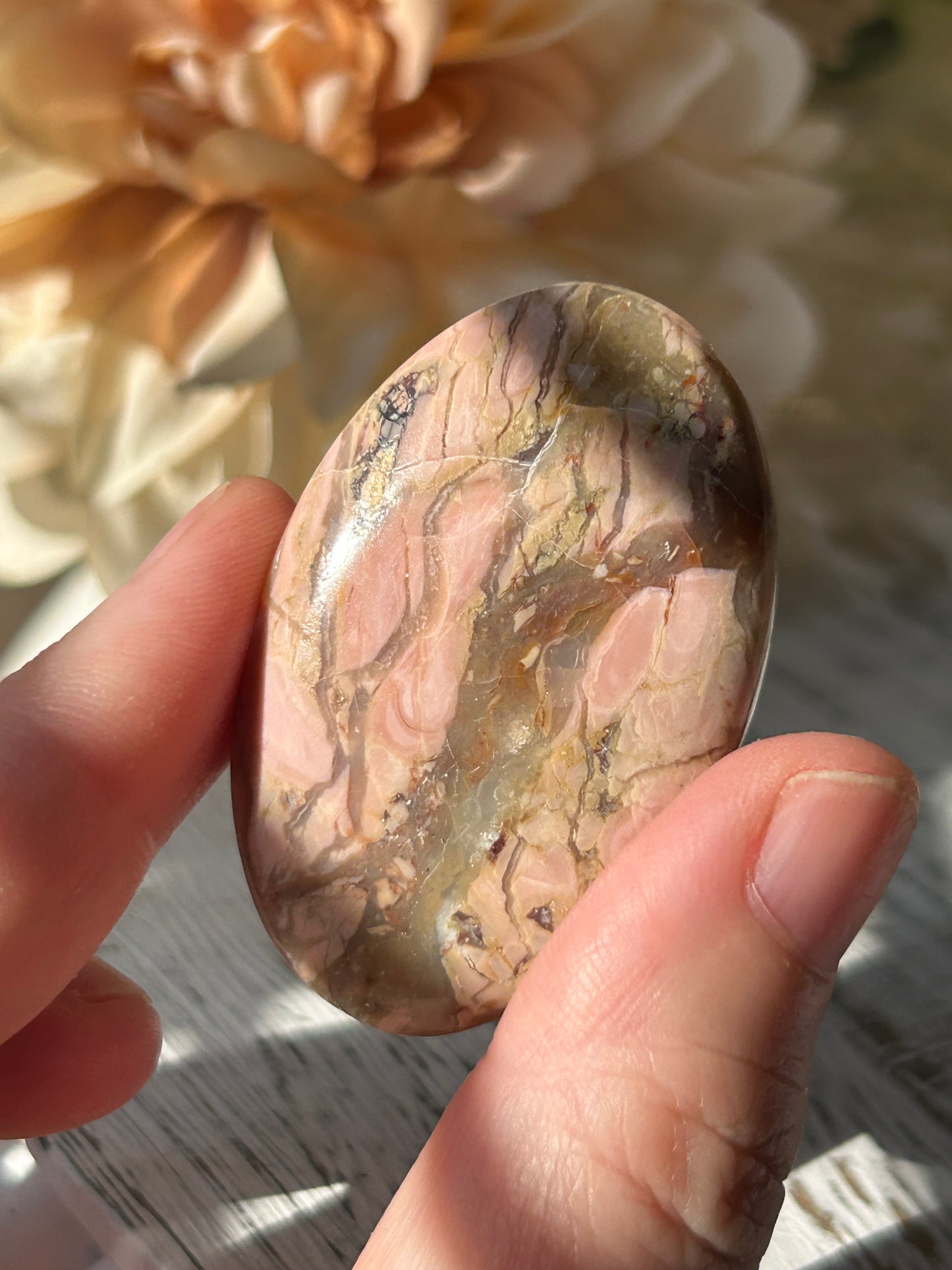 Pink Australian Opal palm stone with soft blush tones, polished finish, and natural patterns.