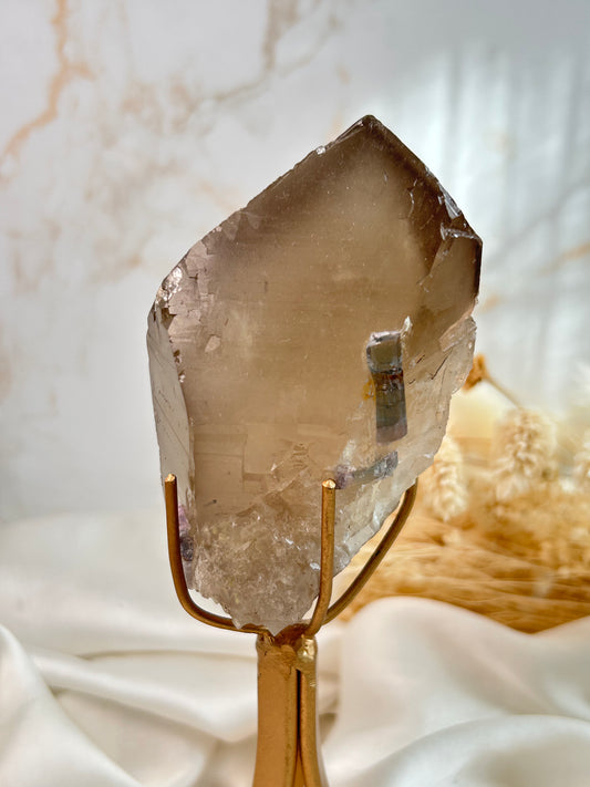 Natural Citrine with Tourmaline inclusion in soft neutral lighting