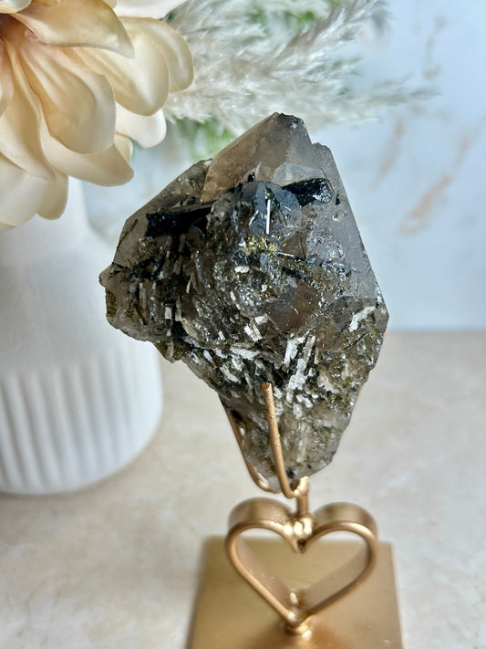 Natural tourmaline and epidote crystal cluster specimen on gold display stand with deep green epidote crystals.