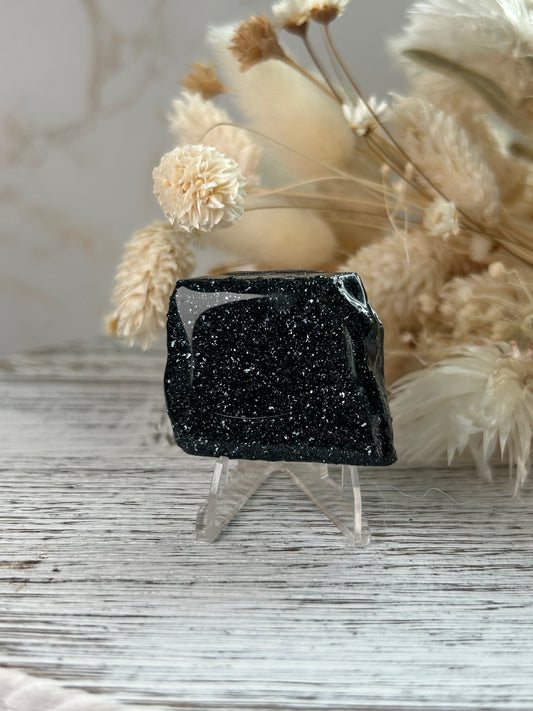 Specularite crystal with mirror-like sparkle and protective coating