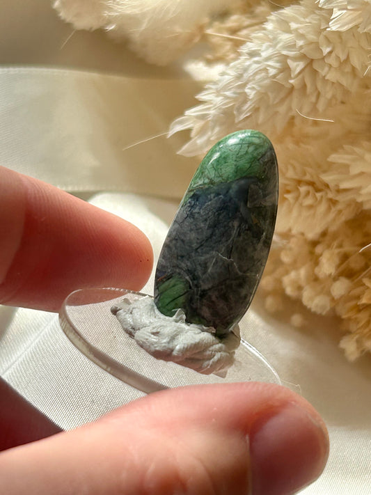 Polished green Smaragdite cabochon from France with visible actinolite inclusions – jewellery safe stone