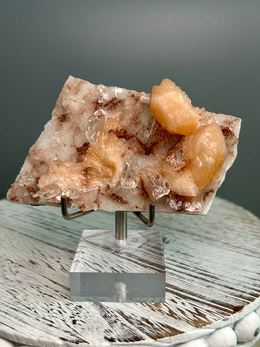 Apophyllite and Stilbite mineral specimen on matrix from Sangamner India, peach stilbite crystals and clear apophyllite cluster on acrylic stand.