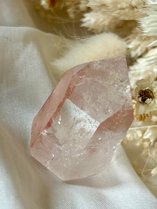 Semi-polished Scarlet Temple Lemurian crystal with soft red hematite glow, standing upright on neutral backgroun