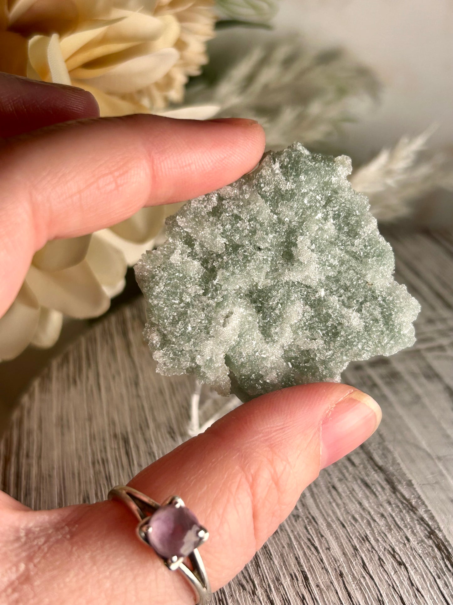 Mini Natural Green Apophyllite crust crystal cluster with sparkling druzy points on display stand from India