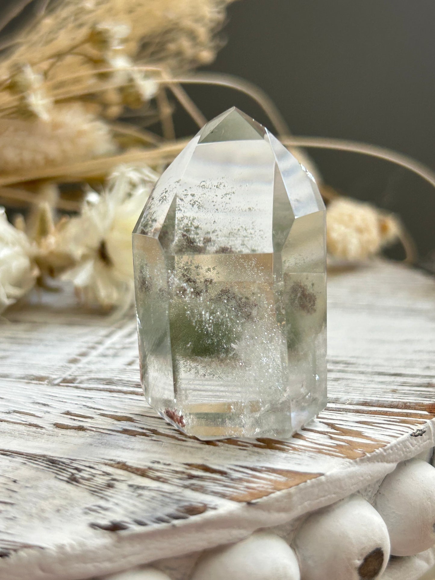 Chlorite phantom quartz point showing green chlorite inclusions and layered phantom growth within clear quartz.