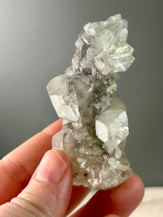 Clear apophyllite stalactite cluster on display, sparkling crystal formation