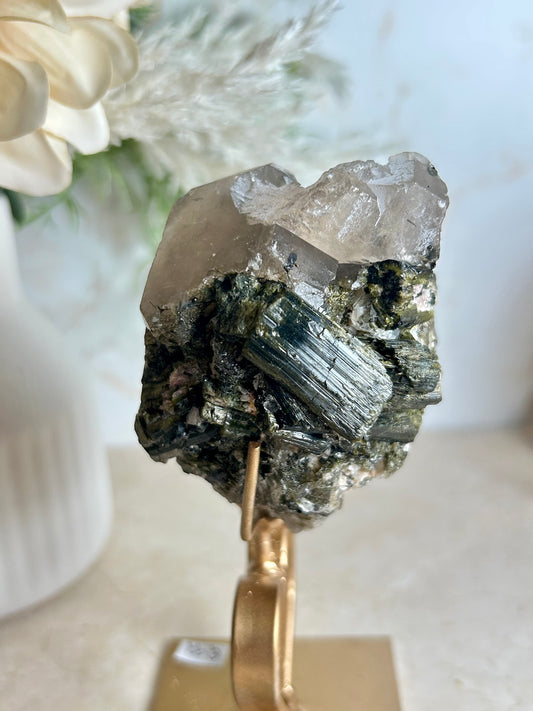 Natural tourmaline and epidote crystal cluster specimen on gold display stand with deep green epidote crystals.