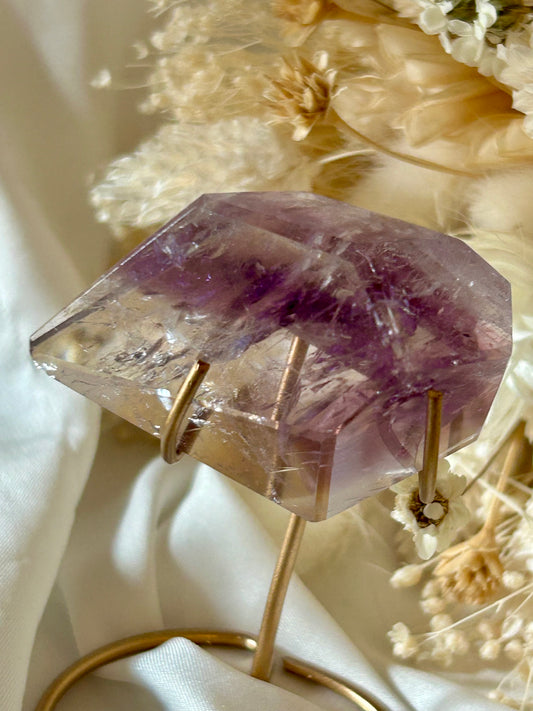 Gem-quality Phantom Amethyst freeform with visible internal layering and rich violet tones, standing upright on a soft background