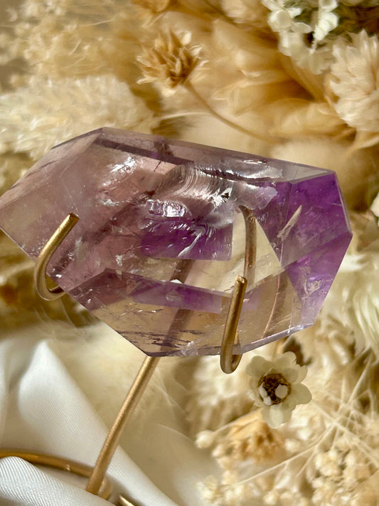 Gem-quality Phantom Amethyst freeform with visible internal layering and rich violet tones, standing upright on a soft background