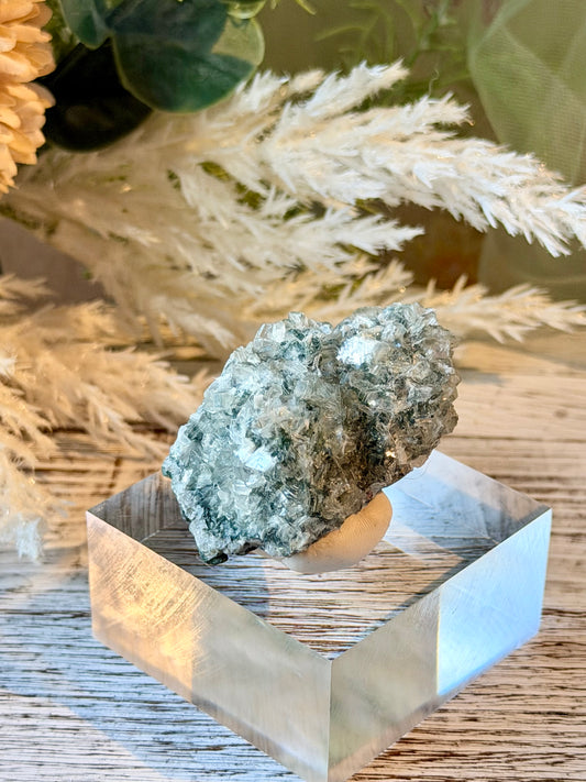 Alien Heulandite mineral specimen featuring intricate translucent crystal clusters, silvery-blue tones, and natural crystalline growth.