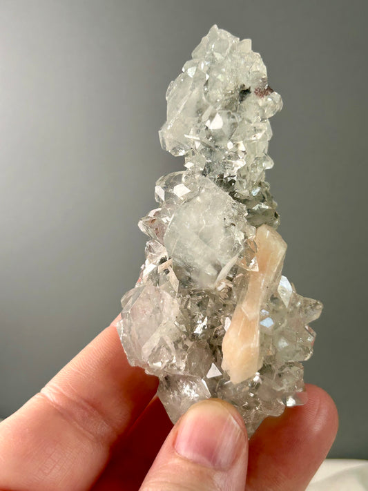 Clear apophyllite stalactite cluster on display, sparkling crystal formation