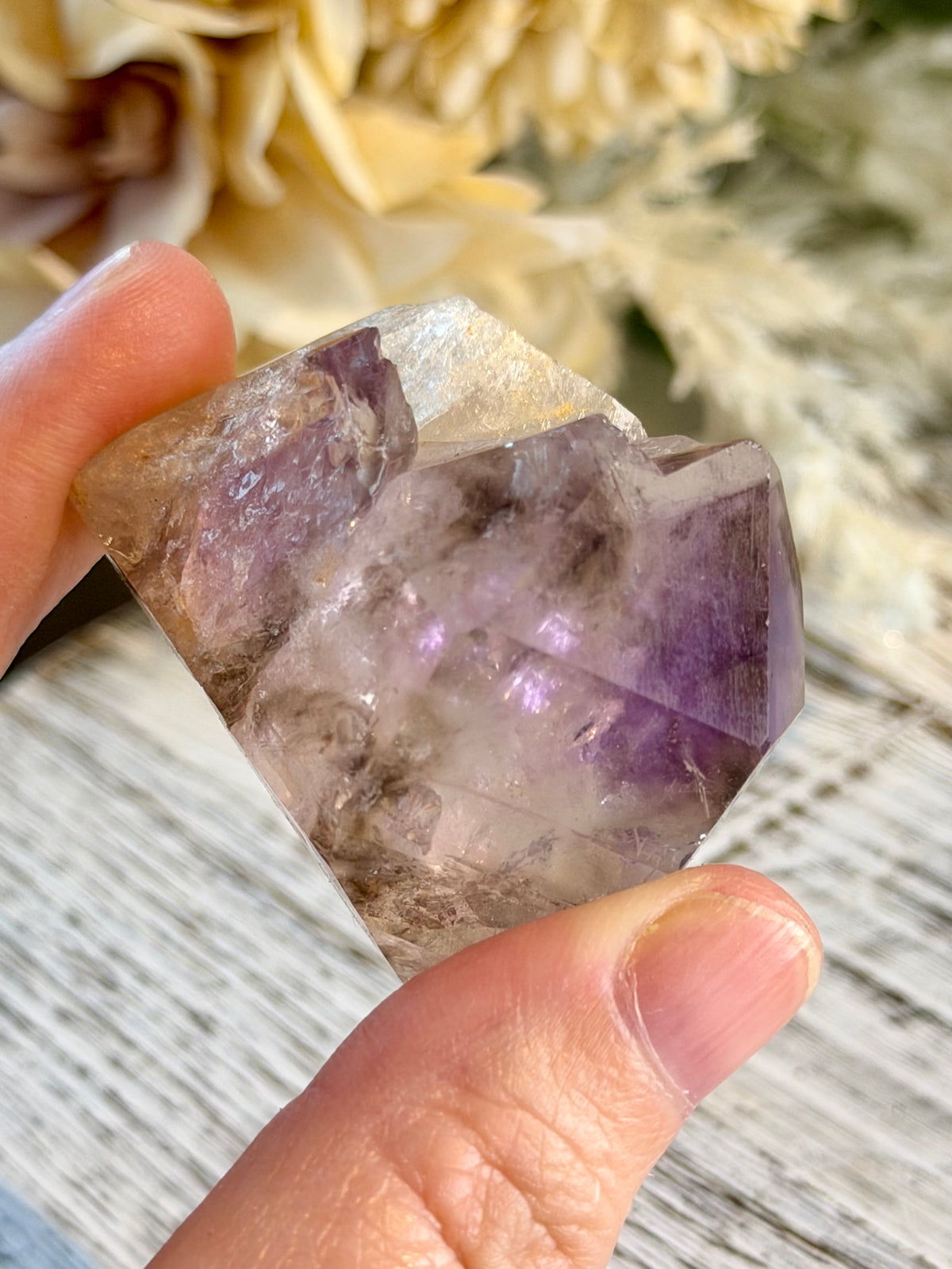 Polished Brazilian Amethyst Elestial with purple tones and intricate layered natural crystal formations.