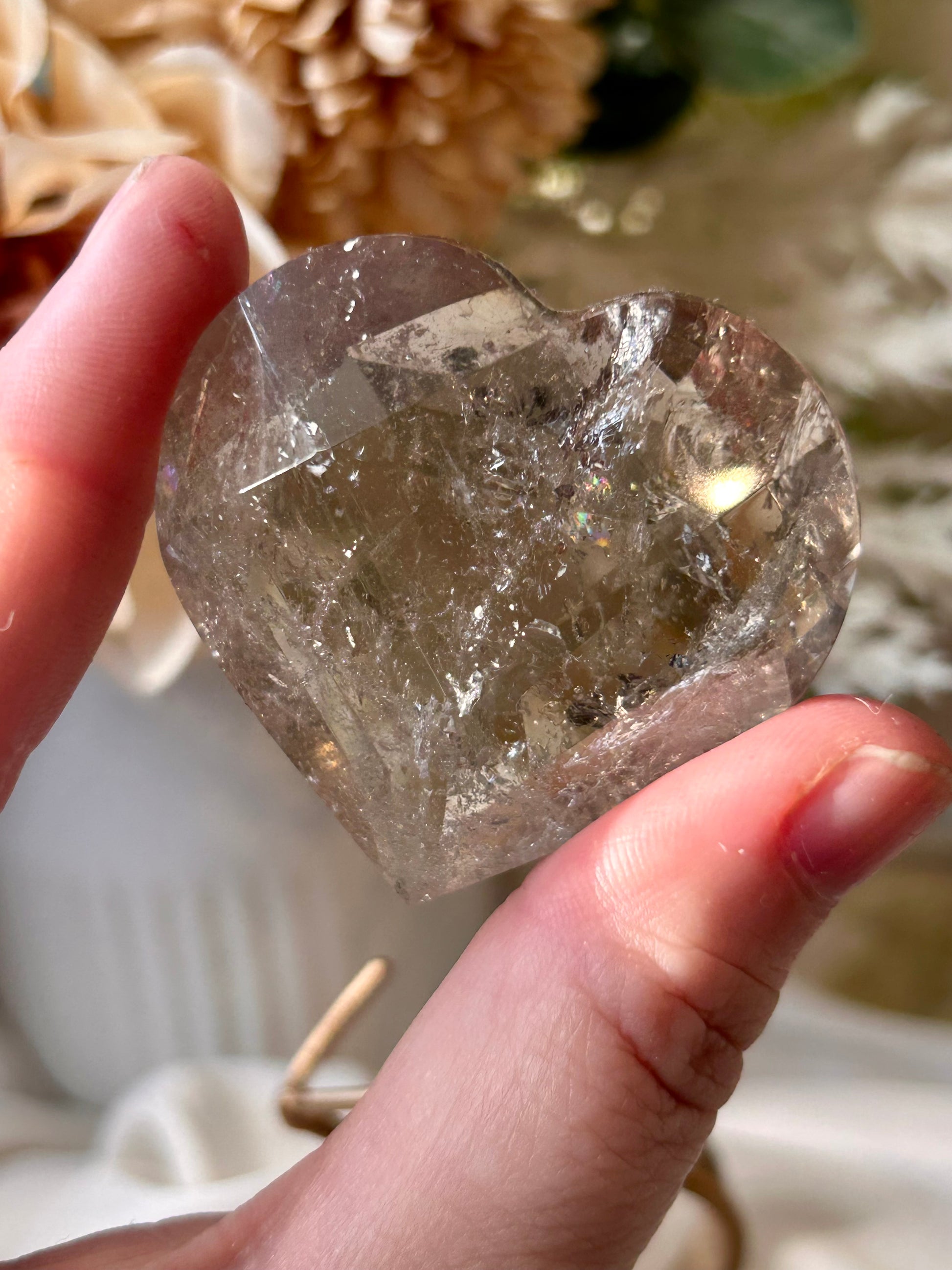 Faceted Smoky Quartz heart with natural smoky tones and custom crystal display stand.
