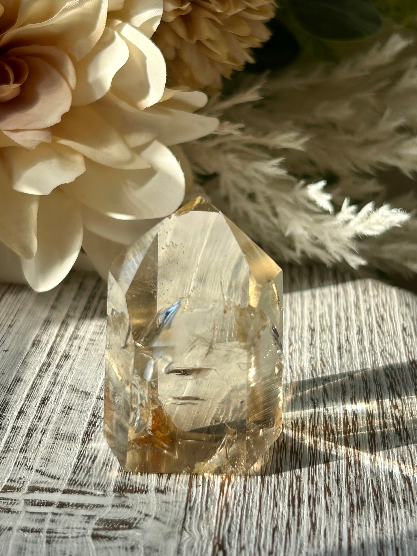 Polished Citrine tower displaying warm honey-gold tones, natural crystal inclusions, and beautiful clarity.