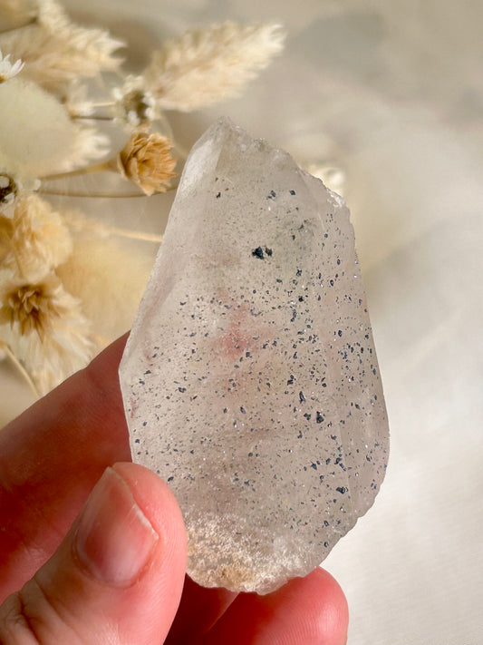 Clear Quartz point with blue inclusions Anatase or Hematite