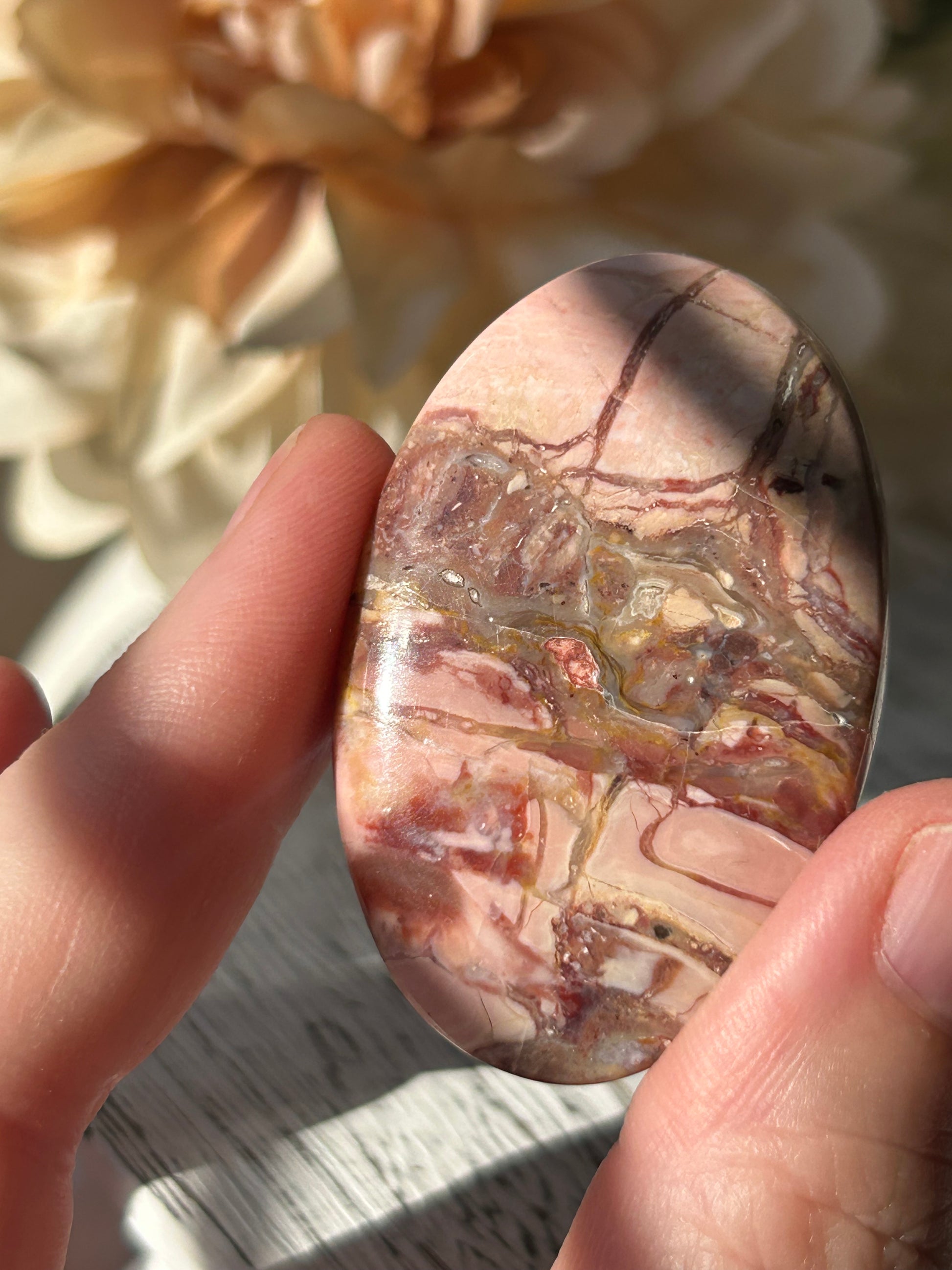 Pink Australian Opal palm stone with soft blush tones, polished finish, and natural patterns.