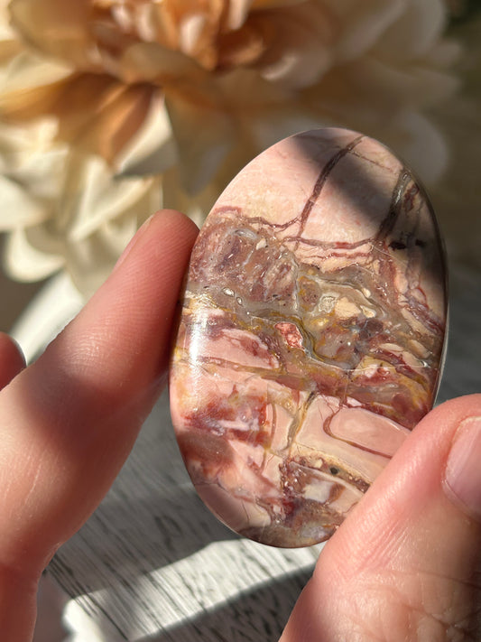 Pink Australian Opal palm stone with soft blush tones, polished finish, and natural patterns.