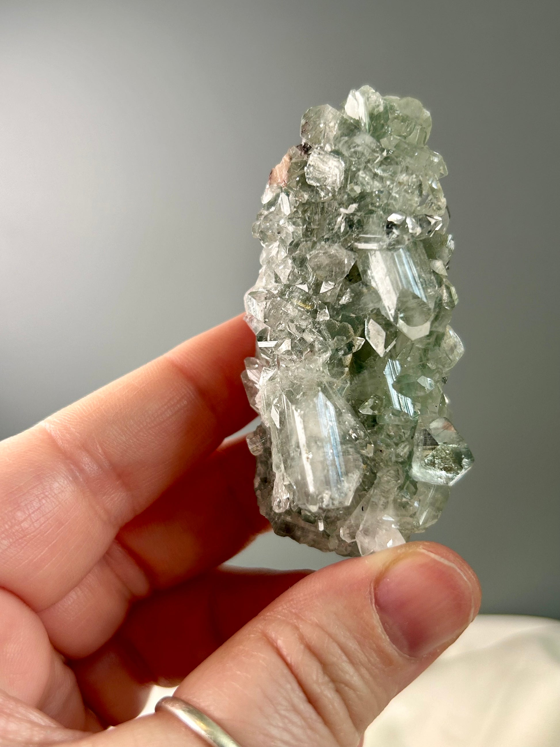 Clear apophyllite stalactite cluster on display, sparkling crystal formation