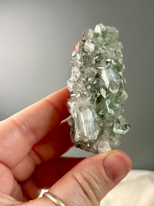 Clear apophyllite stalactite cluster on display, sparkling crystal formation