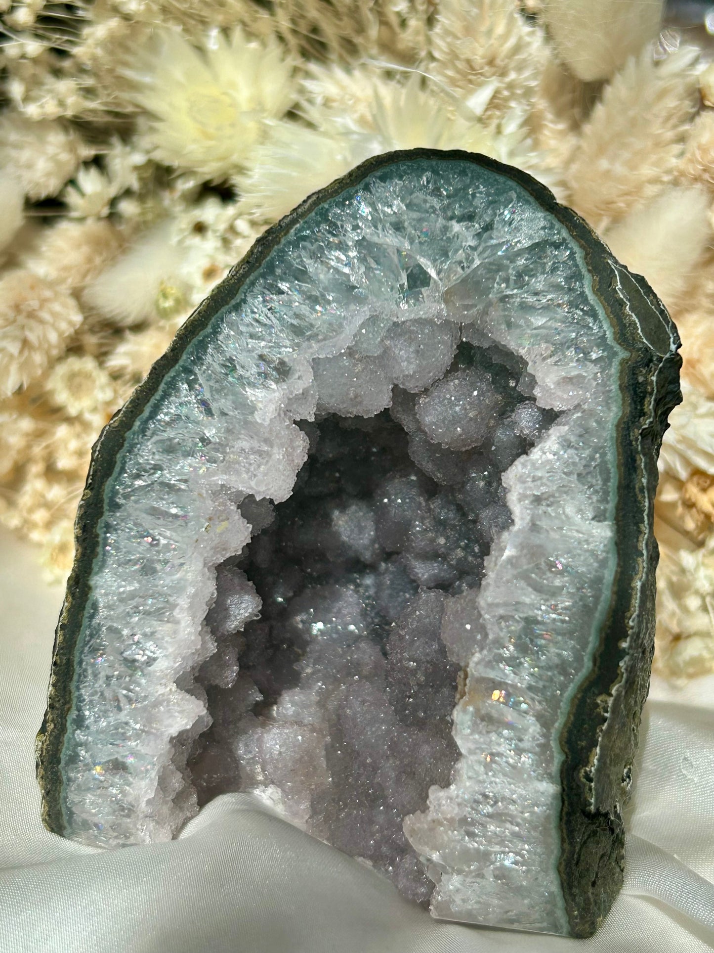 Lavender Amethyst cathedral geode with sparkly druzy crystals, layered banding and deep quartz cave, styled with dried cream florals