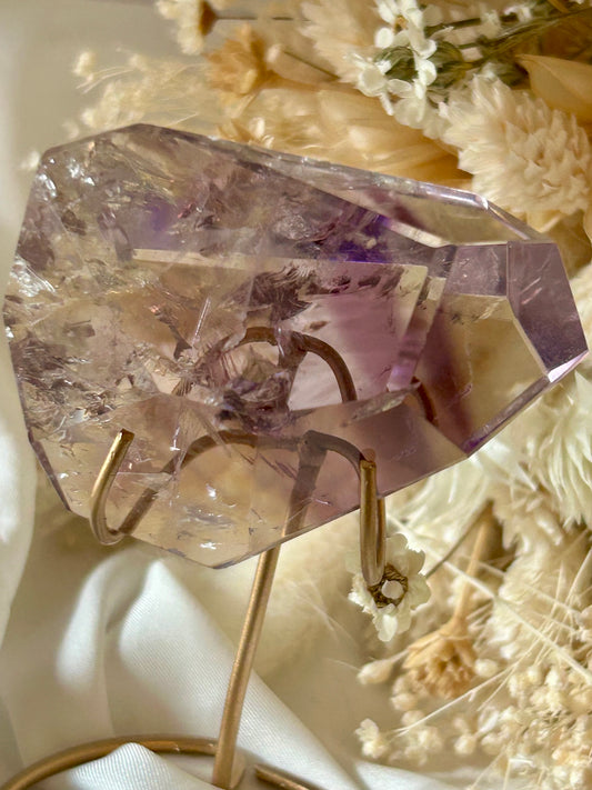 Gem-quality Phantom Amethyst freeform with visible internal layering and rich violet tones, standing upright on a soft background