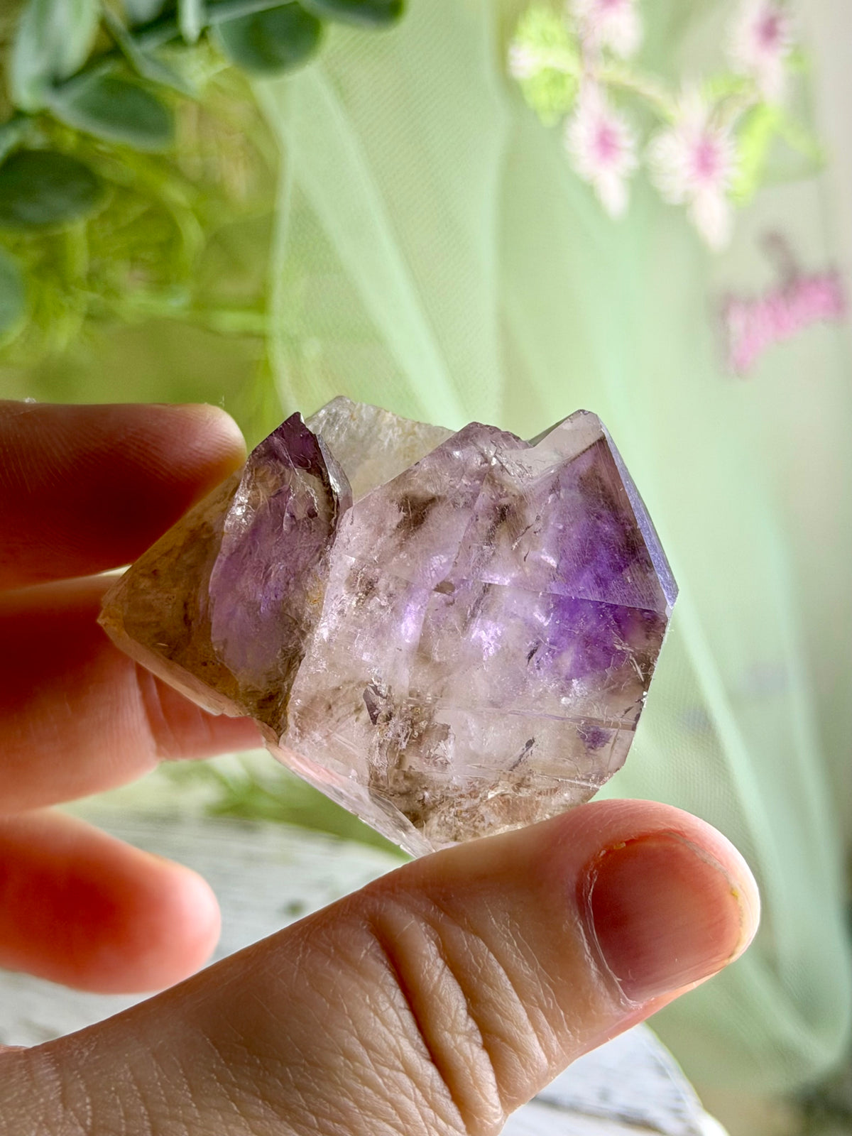 Polished Brazilian Amethyst Elestial with purple tones and intricate layered natural crystal formations.