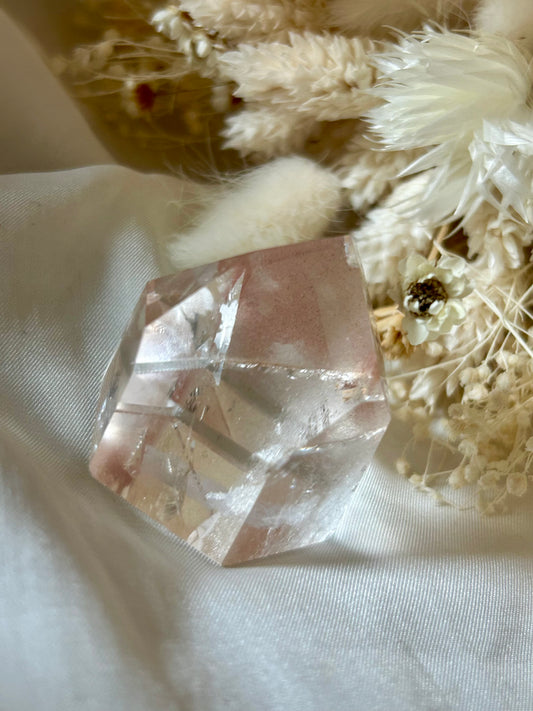 Semi-polished Scarlet Temple Lemurian crystal with soft red hematite glow, standing upright on neutral background
