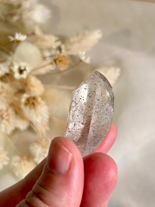 Clear Quartz point with blue inclusions, Anatase or Hematite