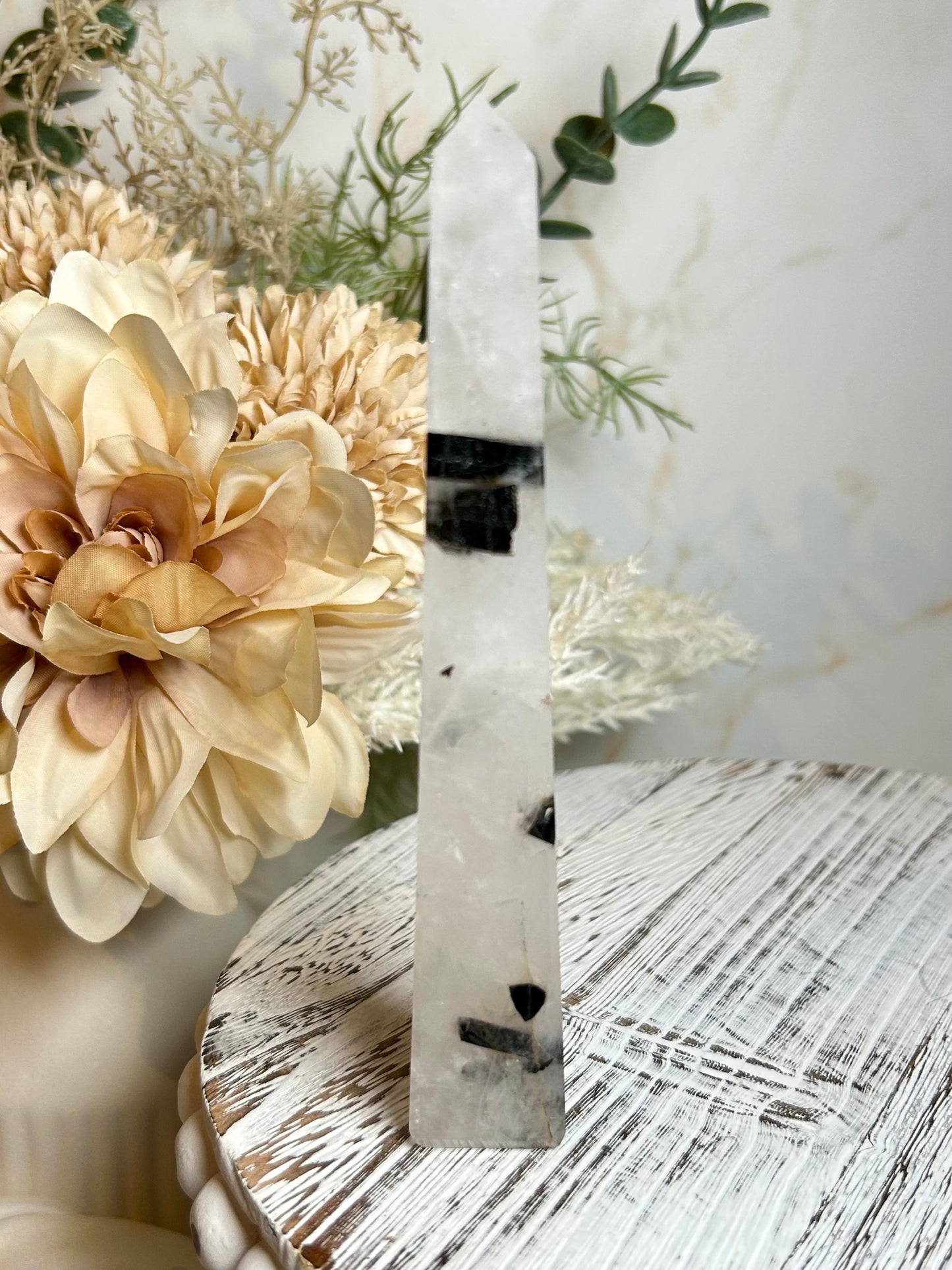 Natural tourmalinated quartz tower with black tourmaline inclusions, polished and photographed in soft natural light