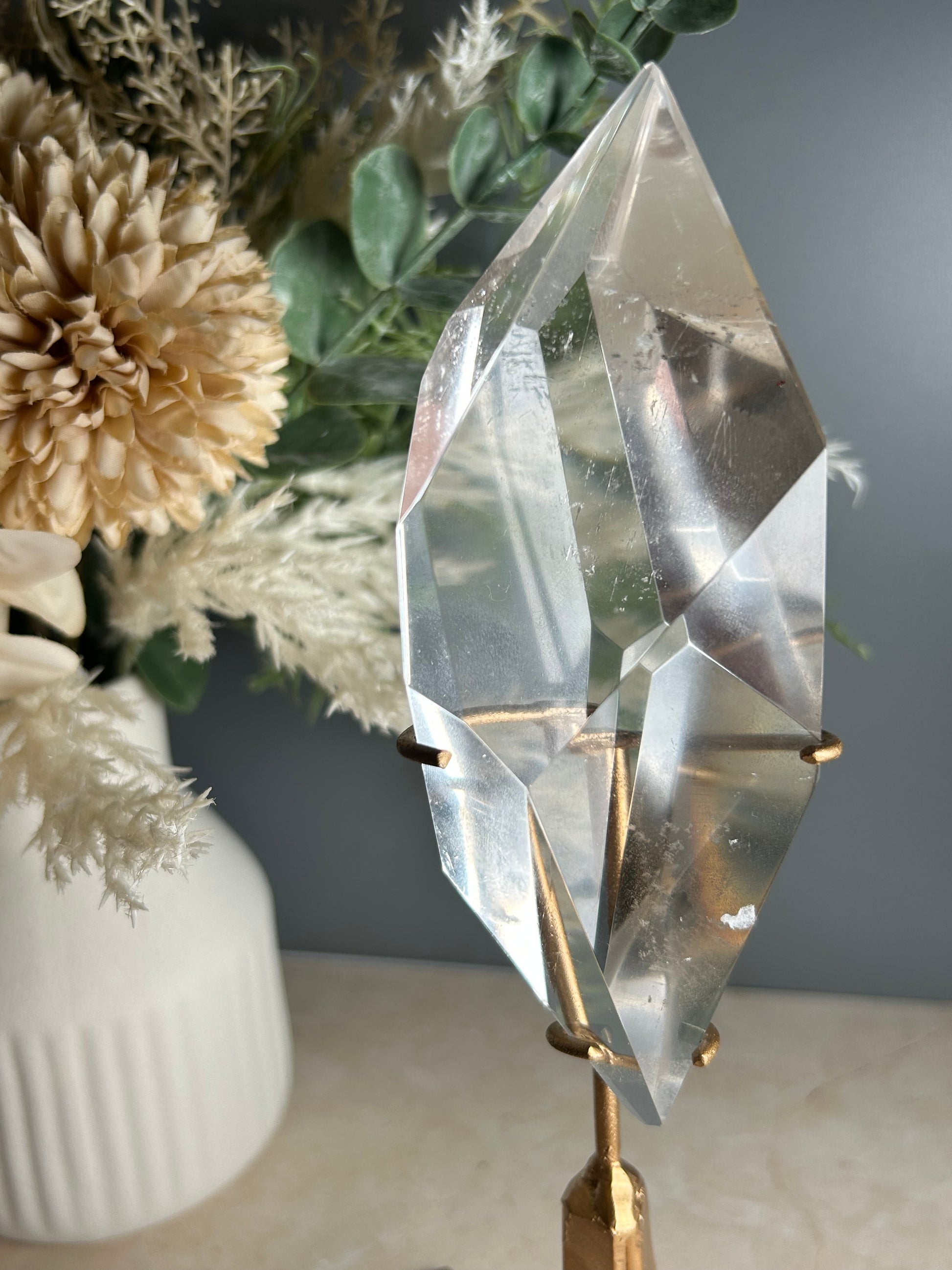 high grade polished clear quartz freeform crystal on gold display stand natural quartz specimen