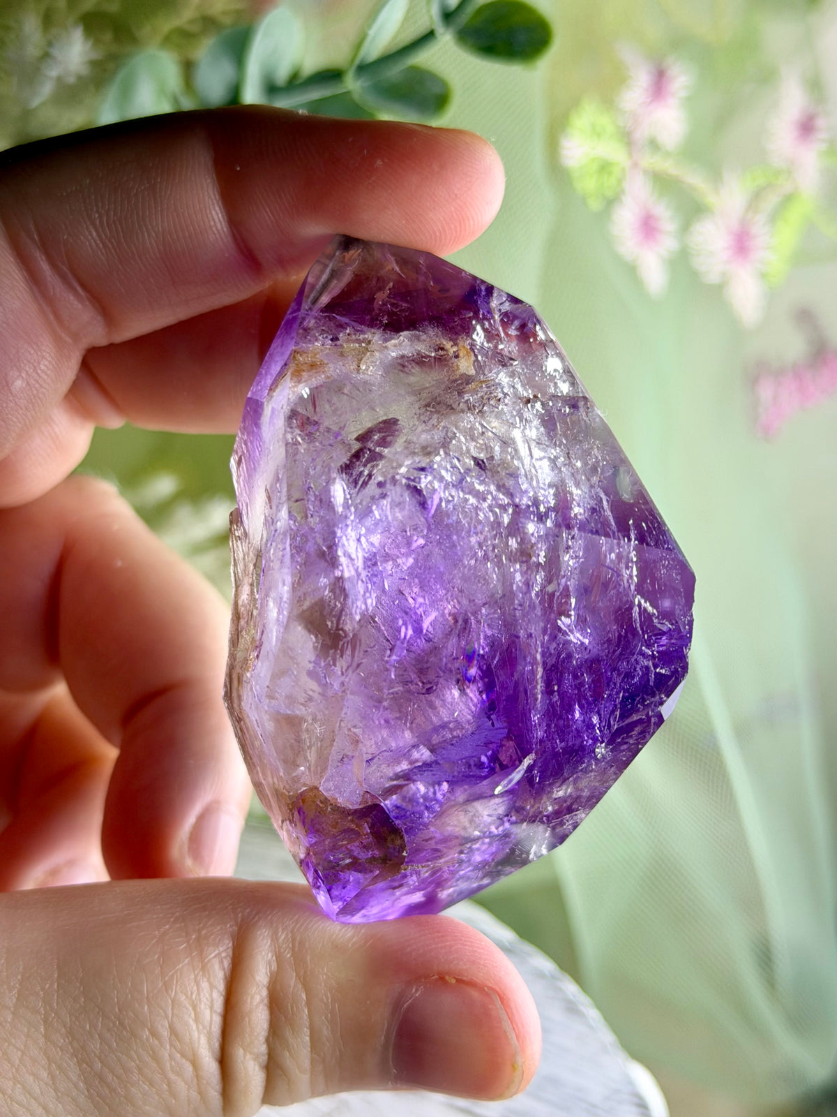 Polished Brazilian Amethyst Elestial with purple tones and intricate layered natural crystal formations.