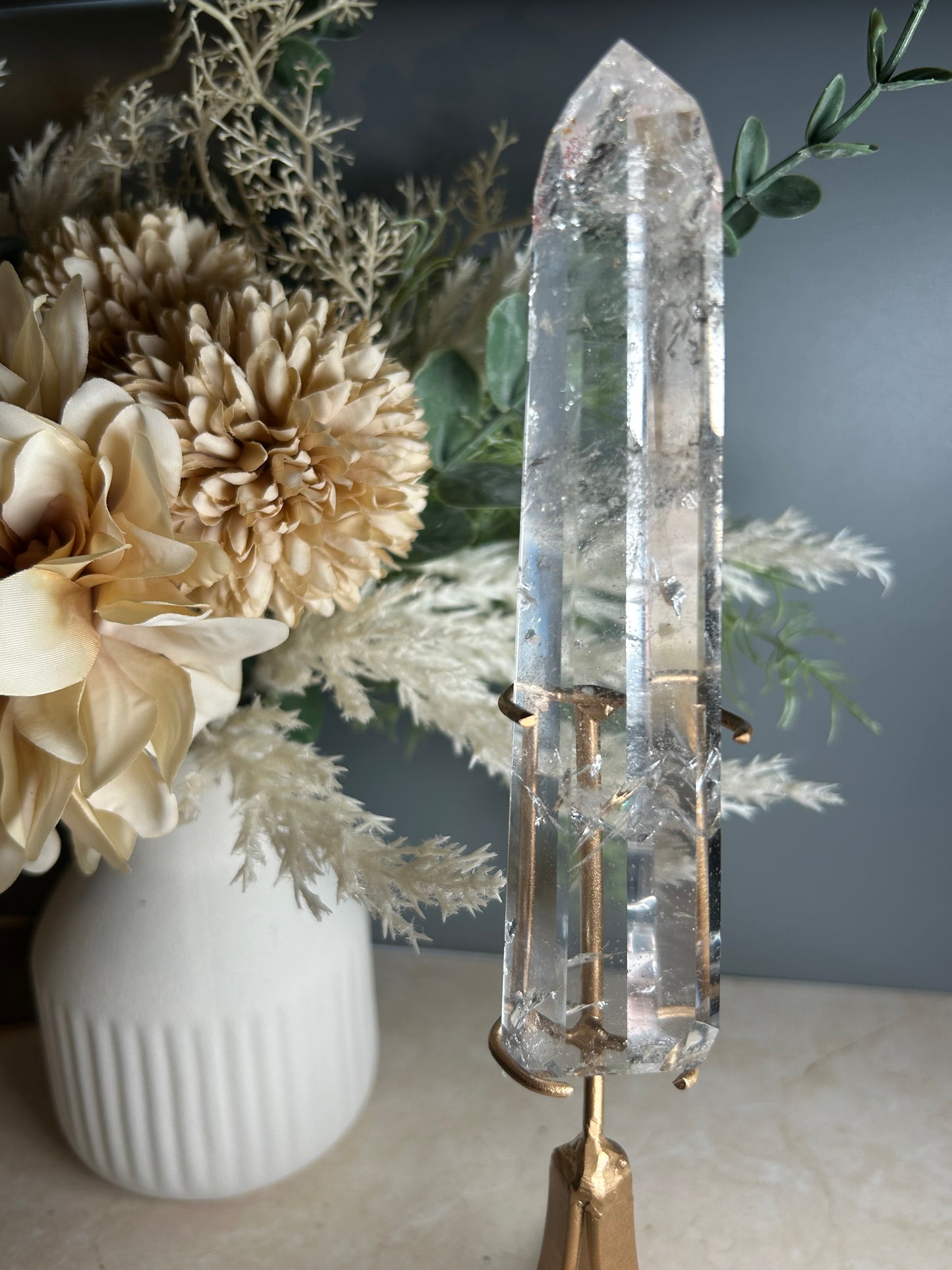 high grade polished clear quartz freeform crystal on gold display stand natural quartz specimen