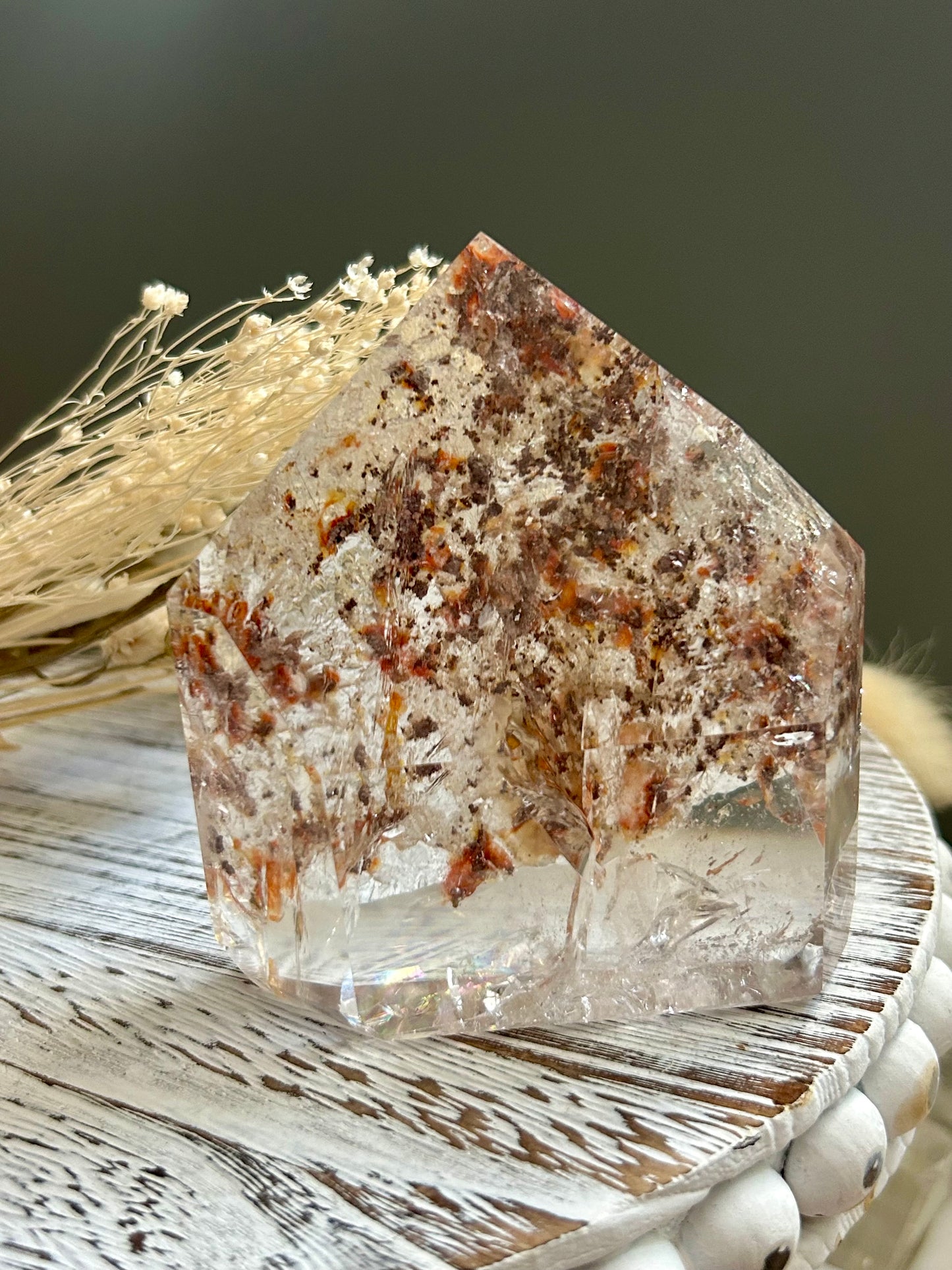Brazilian lodolite quartz crystal point displaying unique inclusion patterns.
