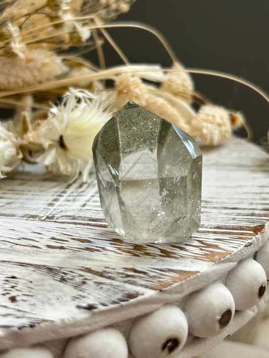Chlorite phantom quartz point showing green chlorite inclusions and layered phantom growth within clear quartz.